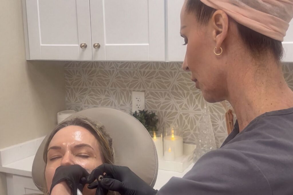 Esthetician Performing Facial Treatment.
